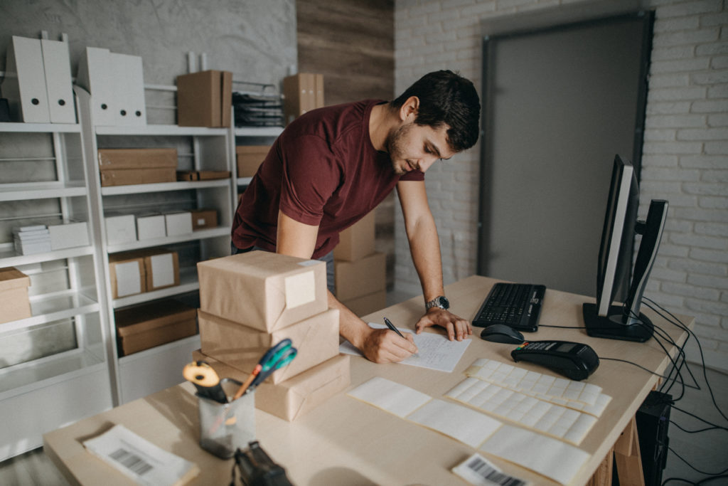 man preparing packages for shipping